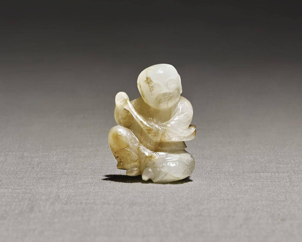 A RARE WHITE AND RUSSET JADE 'MUSICIAN' PENDANT SONG